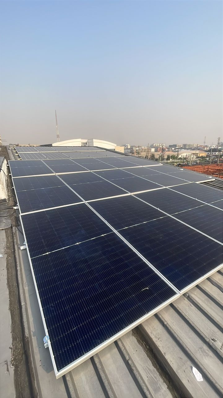 Solar panel array installed across a commercial metal roof in Lagos, Nigeria